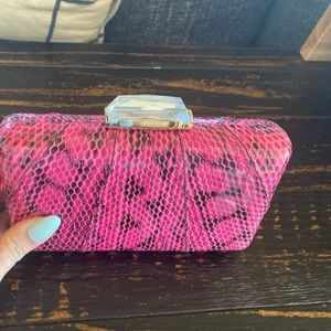 Stunning and fun.Pink clutch snakeskin look textured, gem on top and chain strap